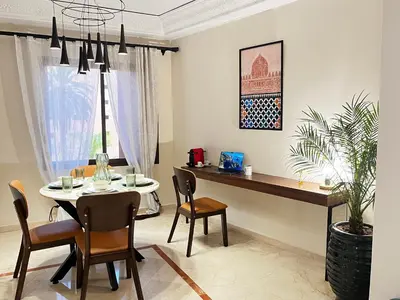 a dining room with a table and chairs at Quiet & Central 1BR Apart with Pool in Gueliz in Marrakech
