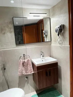 a bathroom with a sink and a mirror and a toilet at Quiet & Central 1BR Apart with Pool in Gueliz in Marrakech