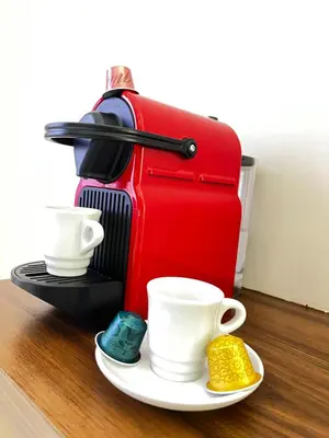 a coffee maker with cups and saucers on a table at Quiet & Central 1BR Apart with Pool in Gueliz in Marrakech