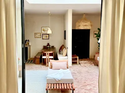 a living room with a bed and a room with a table at Dar 43 with Private Pool Breakfast Included in Marrakech