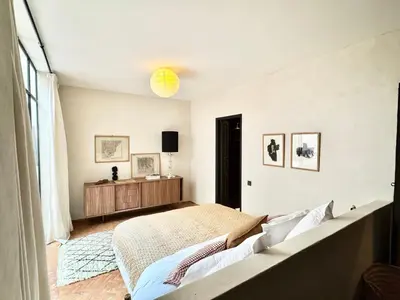 a bedroom with a bed and a large window at Dar 43 with Private Pool Breakfast Included in Marrakech