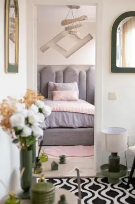 a bedroom with a purple bed and a table with flowers at Grand appartement Guéliz in Marrakech