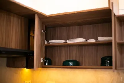 a cupboard with wooden shelves in a room at Grand appartement Guéliz in Marrakech