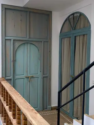 a pair of doors in a room with a staircase at Riad Fontaine Arabe Privatisation in Marrakech