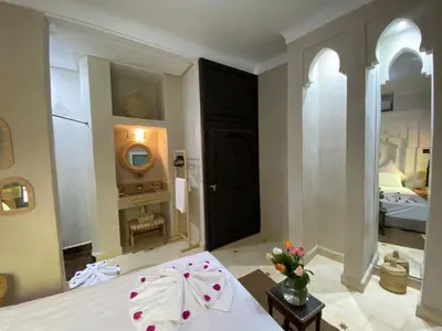 a room with a bed and a room with a bedroom at Riad Fontaine Arabe Privatisation in Marrakech