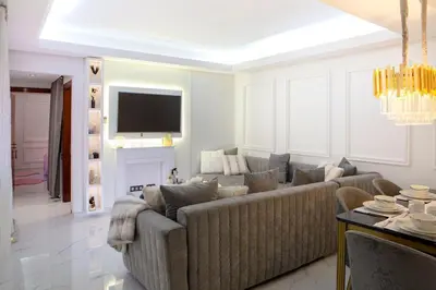 a living room with a couch and a tv at Luxurious apartment in Marrakech