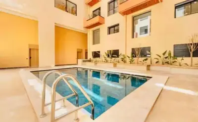 a swimming pool in the middle of a house at Premium studio - Hivernage Marrakech in Marrakech