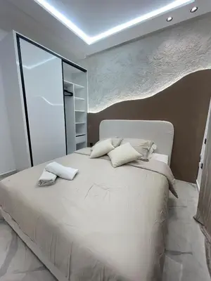 a bedroom with a large white bed with two pillows at Premium studio - Hivernage Marrakech in Marrakech