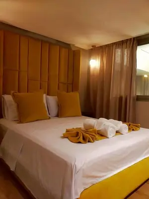 a large white bed with towels on top of it at High Standing Duplex & Pool 10 min Center in Marrakech
