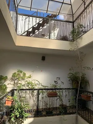 a building with a balcony with plants on it at Riad Zinnha 2 in Marrakech