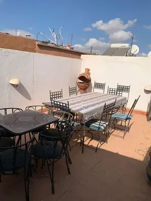 a table and chairs sitting on a patio at Riad Zinnha 2 in Marrakech