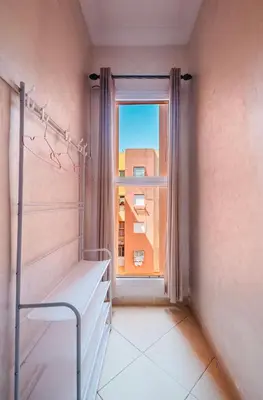 an empty room with a window and a bed at Marrakech Chic apartment in Marrakech