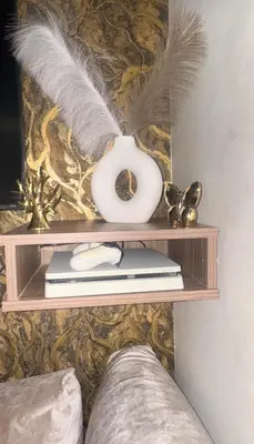 a shelf with a white vase and feathers on it at Marrakech Chic apartment in Marrakech