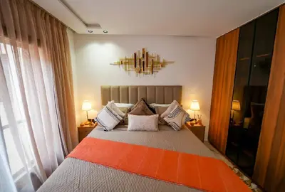 a bedroom with a bed with pillows on it at Magnifique Appartement Hivernage in Marrakech