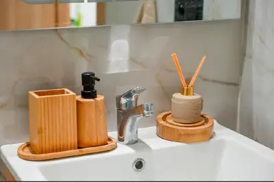 a bathroom sink with two wooden soap dispensers on it at Magnifique Appartement Hivernage in Marrakech