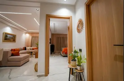 a living room with a couch and a table at Magnifique Appartement Hivernage in Marrakech