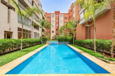 a swimming pool in the middle of a building at Appartement moderne 5 min au centre ville in Marrakech