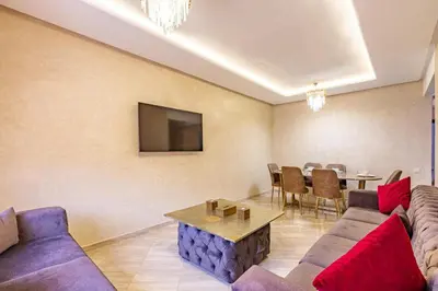 a living room with a couch and a table at Appartement moderne 5 min au centre ville in Marrakech