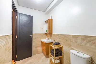 a bathroom with a toilet and a sink at Appartement moderne 5 min au centre ville in Marrakech