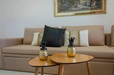 two coffee tables in front of a couch at Appartement Domaine de Nouria in Marrakech