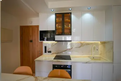 a kitchen with white cabinets and a counter top at Appartement Domaine de Nouria in Marrakech