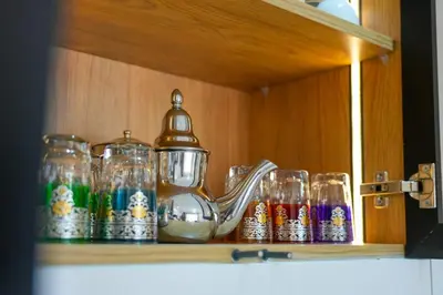 a tea pot and glasses sitting on a shelf at Appartement Domaine de Nouria in Marrakech