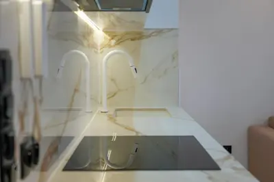 a glass counter top with two faucets on it at Appartement Domaine de Nouria in Marrakech