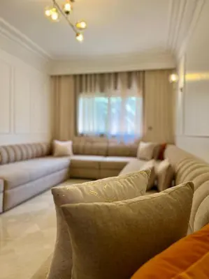 a living room with couches and a couch at Bel appartement à Babylone 1 in Marrakech