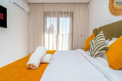 a bedroom with a large white bed with towels on it at Urban Escape in Gueliz with Balcony and Wifi in Marrakech