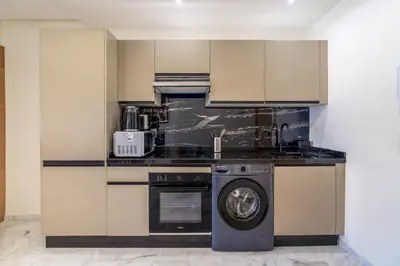 a kitchen with a washer and a dishwasher at Urban Escape in Gueliz with Balcony and Wifi in Marrakech