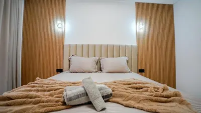 a bed with a blanket and pillows on it at Yasmine Majorelle Residence Apartment in Marrakech