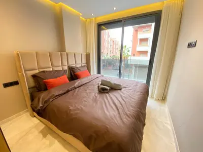 a bedroom with a large bed with a large window at Chic & Confort à Marrakech in Marrakech