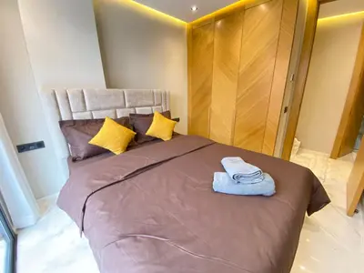 a bedroom with a large bed with two towels on it at Chic & Confort à Marrakech in Marrakech