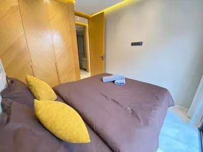 a bedroom with a bed with yellow pillows at Chic & Confort à Marrakech in Marrakech
