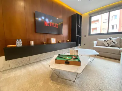 a living room with a tv and a pool table at Chic & Confort à Marrakech in Marrakech