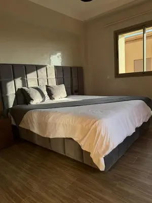 a large bed in a bedroom with a window at Appartement de luxe avec piscine et parking gratuit in Marrakech
