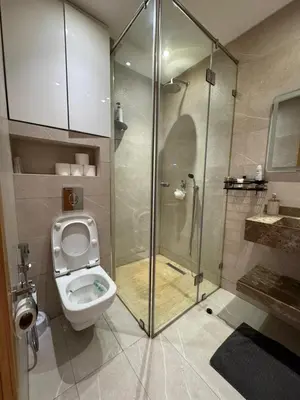 a bathroom with a toilet and a glass shower at Appartement de luxe avec piscine et parking gratuit in Marrakech