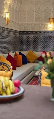 a couch with colorful pillows on it in a room at Riad Kasbah 82 in Marrakech