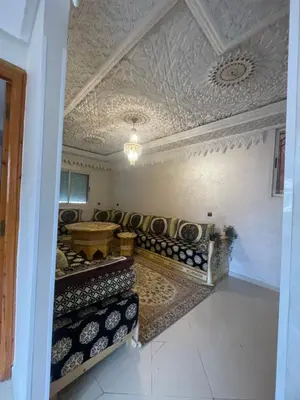 a room with a couch and a table and a ceiling at Résidence Al Aziziya Near Marrakech Airport in Marrakech