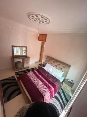 a bedroom with a bed in a room at Résidence Al Aziziya Near Marrakech Airport in Marrakech