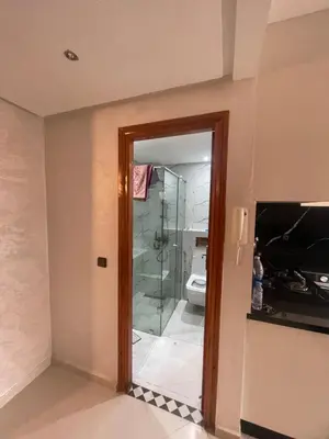 a bathroom with a glass shower and a toilet at Résidence Al Aziziya Near Marrakech Airport in Marrakech