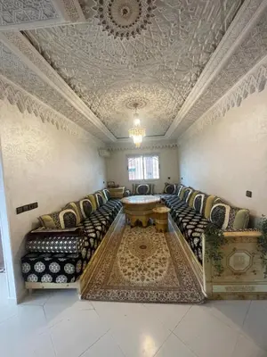 a large living room with couches and a table at Résidence Al Aziziya Near Marrakech Airport in Marrakech