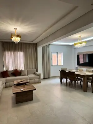 a living room with a couch and a table at Le style a marrakech in Marrakech