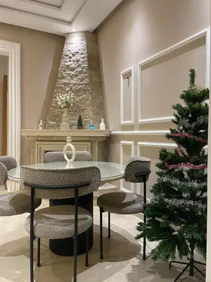 a dining room with a christmas tree and a table and chairs at Majorelle Apartment YSL in Marrakech