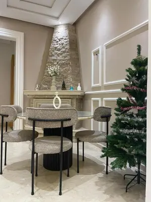 a christmas tree in a room with a table and chairs at Majorelle Apartment YSL in Marrakech