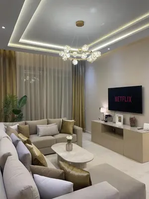 a living room with a couch and a tv at Majorelle Apartment YSL in Marrakech