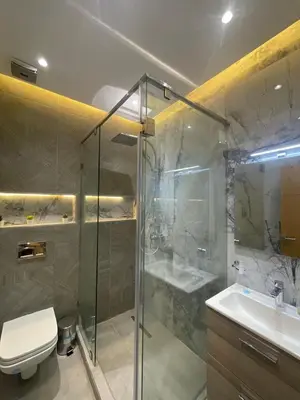 a bathroom with a shower and a toilet and a sink at Majorelle Apartment YSL in Marrakech