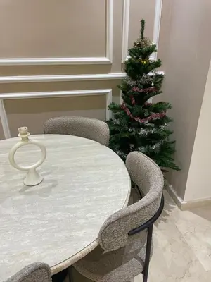 a white table with chairs and a christmas tree at Majorelle Apartment YSL in Marrakech