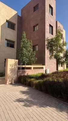 a building with a bench in front of it at Premium Apartment in Marrakech Argan Golf Residence with pool & WiFi in Marrakech