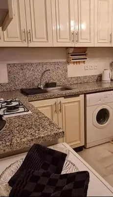 a kitchen with white cabinets and a stove top oven at Nilia in Marrakech